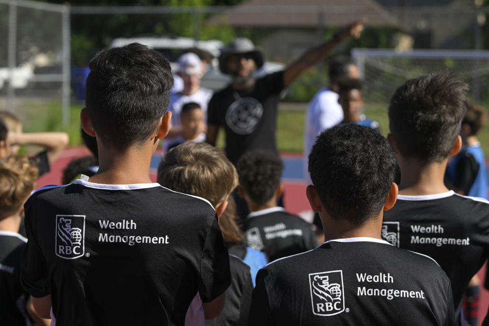 Attendees get instruction from SOL of the Cities co-founder Mario Wimberly during SOL of the Cities Success for Soccer Kickoff at Johnson Senior High School.